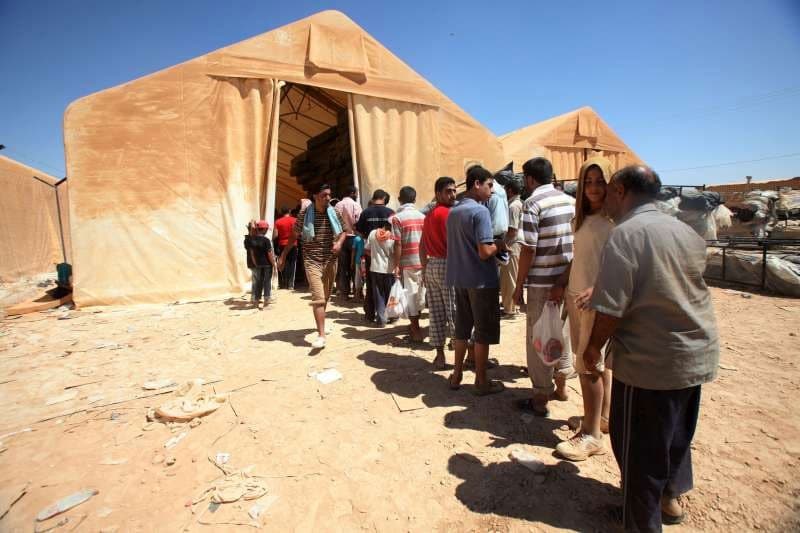 Refugees in Za’atri, Jordan, wait or relief items (UN News Centre 2012)